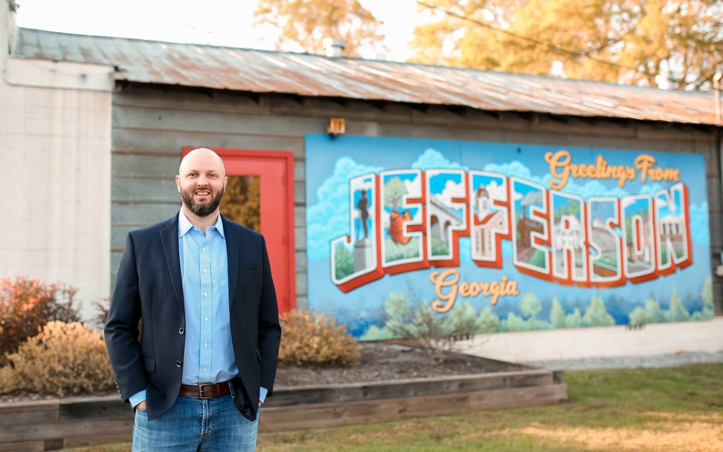 Jerry Parisi standing out front of Jefferson artwork sign