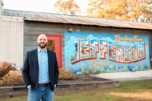 Jerry Parisi standing out front of Jefferson artwork sign