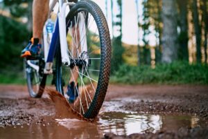 Person,,Cycling,And,Mountain,Biking,In,Nature,With,Wheel,,Mud