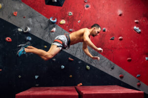 Motion,Shot,Of,Male,Climber,Falling,On,Mat,From,Climber